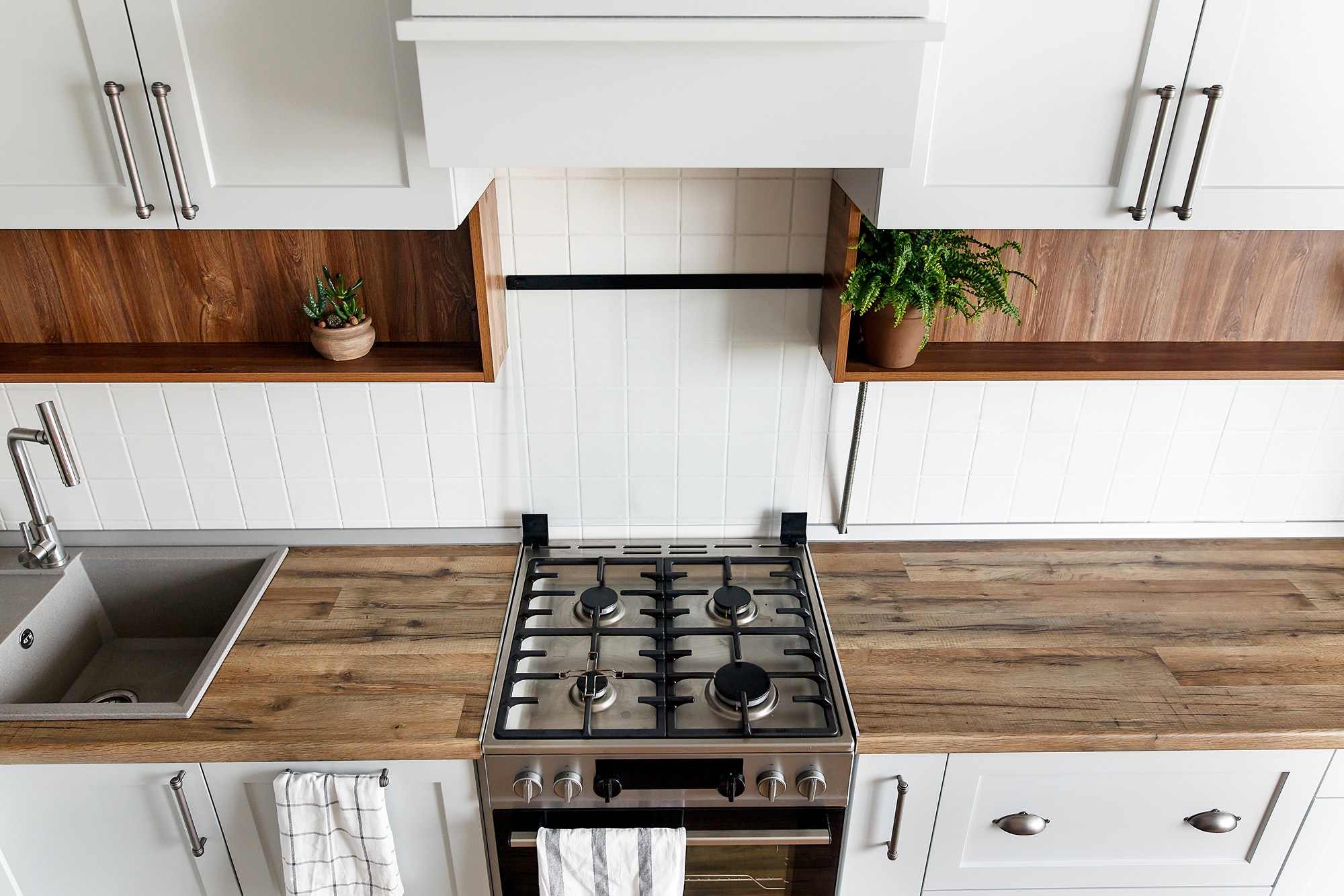 Kitchen interior with furniture and stainless steel appliances in a new house