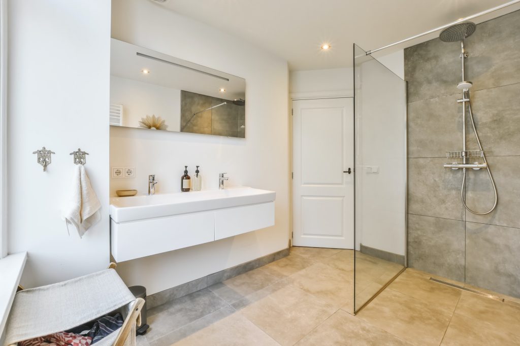 Designer bathroom with beige tiled floor