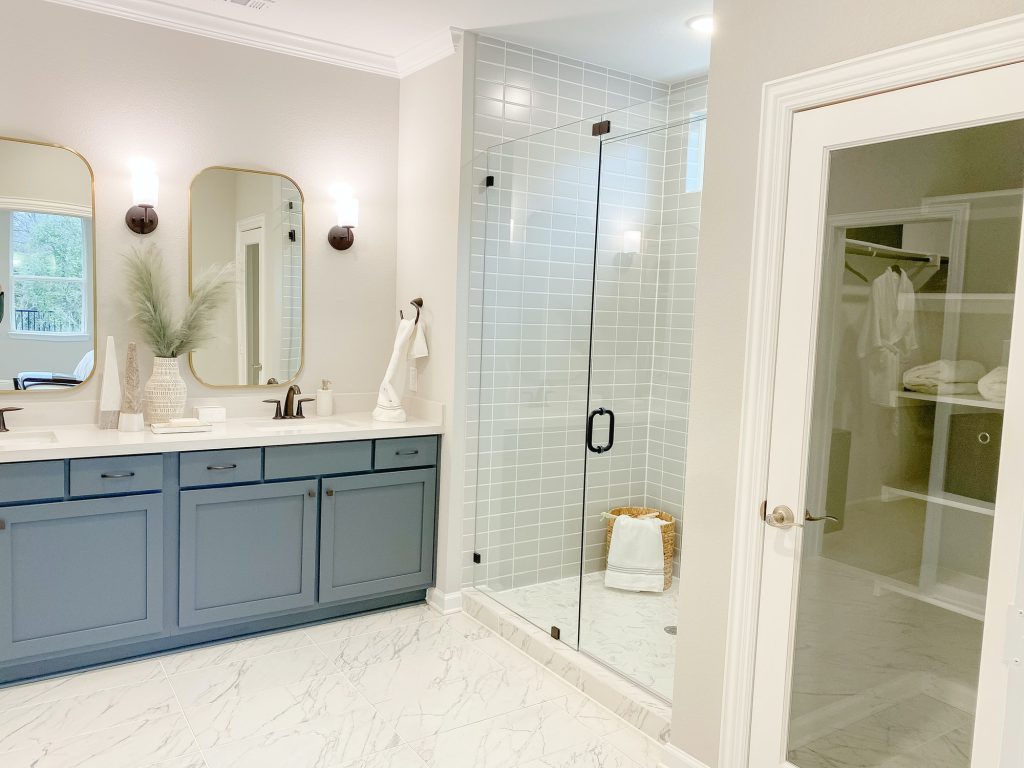 Modern master bathroom with glass and tiled wall in shower